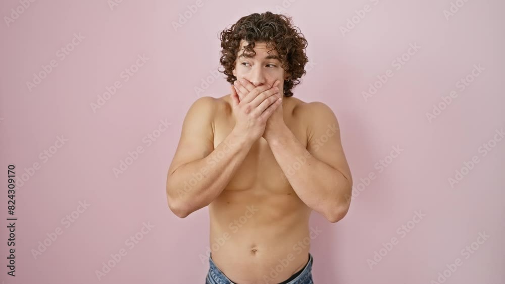Shirtless young hispanic male, hand-covered mouth signifying secretly shocked mistake, stands out against isolated pink wall Shirtless young hispanic male, hand-covered mouth signifying secretly shocked mistake, stands out against isolated pink wall