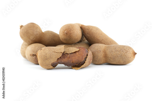 Tamarind whole and cracked open on white background