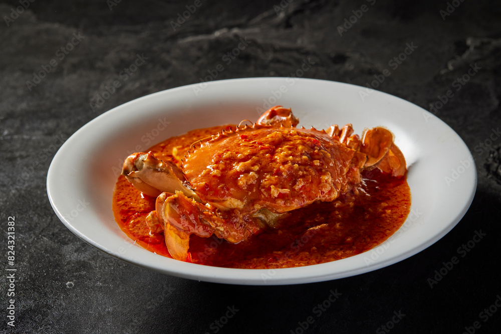traditional chinese wok fried seafood fresh big meat crab with chilli spicy salted egg yolk cheese cream sauce in plate on dark stone table asian cafe hotel luxury halal food restaurant banquet menu