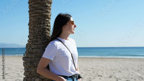 Close-up of a happy woman's face against the background of nature, sea and blue sky. Faith in a bright future