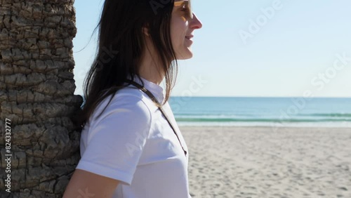 Close-up of a happy woman's face against the background of nature, sea and blue sky. Faith in a bright future