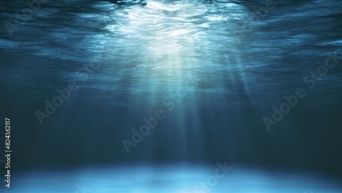 A tranquil underwater scene showing the sun's rays penetrating the ocean's surface and radiating downwards photo