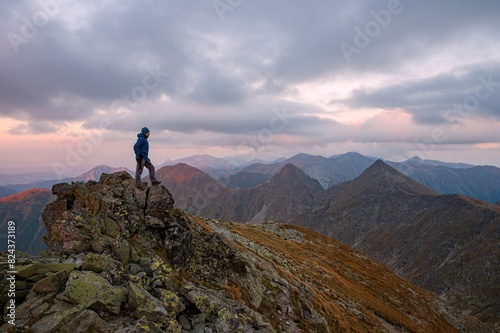 Beautiful mountains at sunset. Man who enjoys a break look at the top of the mountain at sunset adventure travel. © Ivan