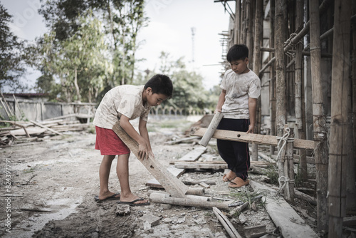  Poor children are forced to work in construction. are forced to work in the construction area. Human rights concepts, stopping child abuse, violence, fear of child labor and human trafficking. © Tinnakorn