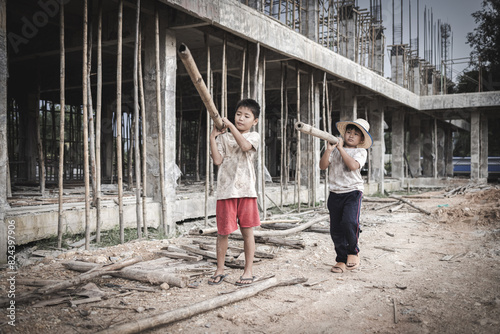 Two poor children are forced to work in construction. Poor children, poverty, Child labor, World Day Against Child Labour concept.