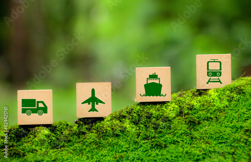 Green Logistics concept. Four wooden blocks, each with a green icon representing Green transportation- a truck, plane, ship, and train. eco-friendly transportation, sustainable logistics. photo