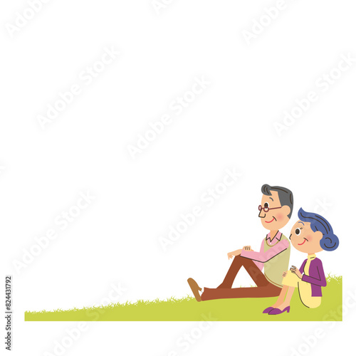 芝生に座って遠くを見つめる老夫婦