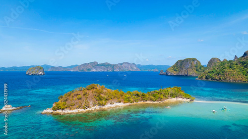 Aerail view of tropical exotic island sand bar separating sea in two with turquoise in El Nido, Palawan, Philippines.