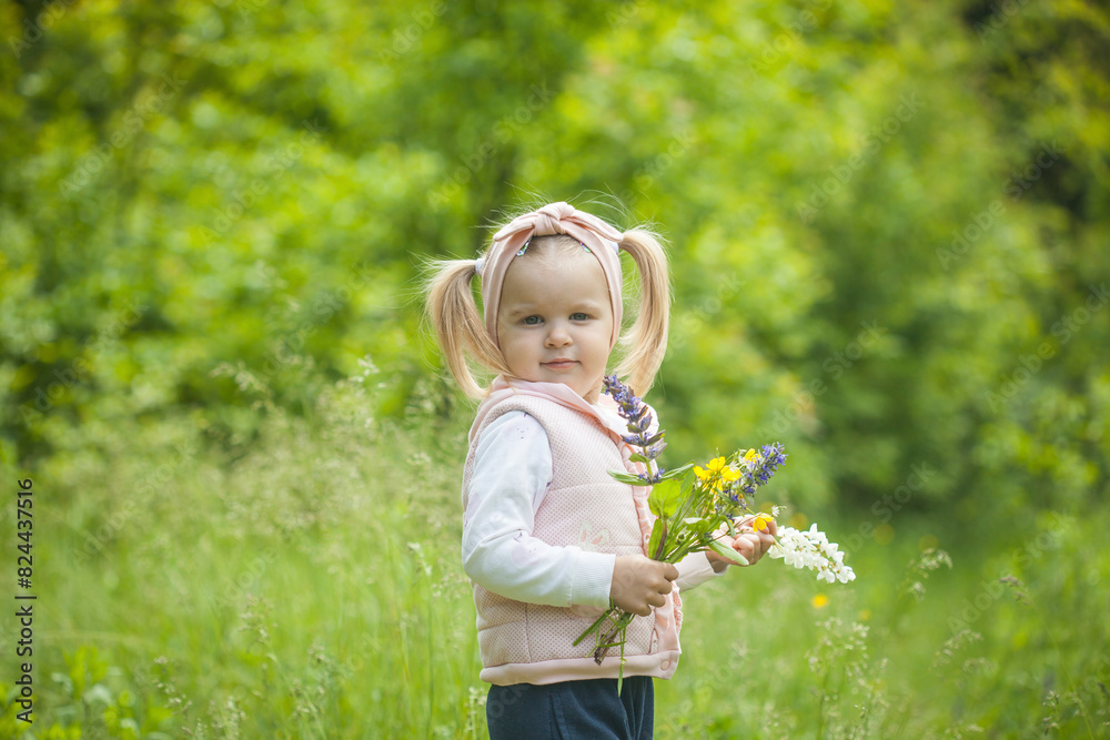 Cute little girl with bouquet of field flowers on the meadow in spring day. happy childhood Cute little girl with bouquet of field flowers on the meadow in spring day. happy childhood