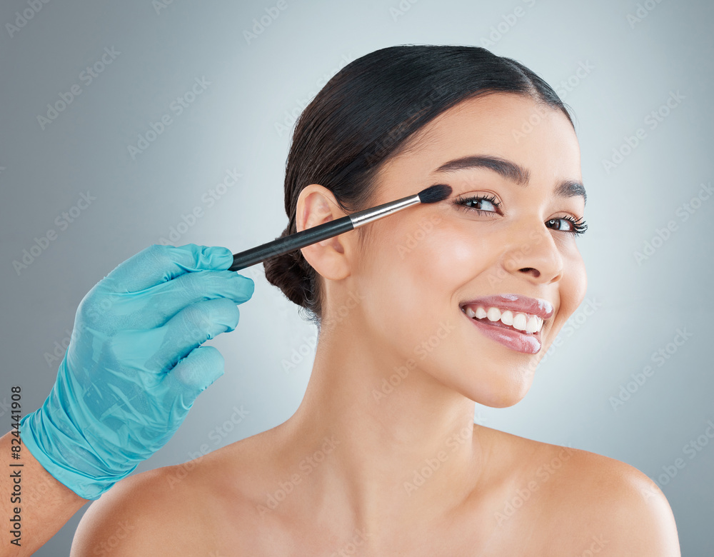 Woman, portrait and hand with makeup brush, eyeshadow and skincare isolated on grey studio background. Face, happy model and artist with cosmetics tool for treatment, beauty and powder application Woman, portrait and hand with makeup brush, eyeshadow and skincare isolated on grey studio background. Face, happy model and artist with cosmetics tool for treatment, beauty and powder application
