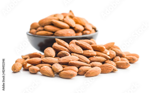 Peeled almond nuts in bowl isolated on white background.