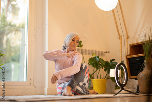 Senior Woman Practicing Yoga at Home with Ring Light