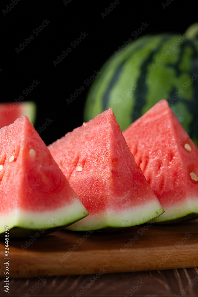 Slices of fresh watermelon on the rustic wooden table Slices of fresh watermelon on the rustic wooden table