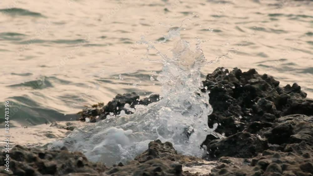 Slow motion video of wave crushing stone on a sea shore. Slow motion video of wave crushing stone on a sea shore.