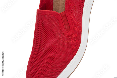 Close-up view of a vibrant red slip-on shoe, featuring intricate mesh texture and fine stitching, crisp white background. stylish design, a white sole, highlighting its comfortable, casual wear appeal