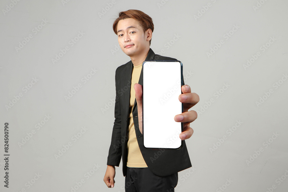 asian business man holding mobile phone and showing blank screen with dislike unhappy expression on isolated background asian business man holding mobile phone and showing blank screen with dislike unhappy expression on isolated background
