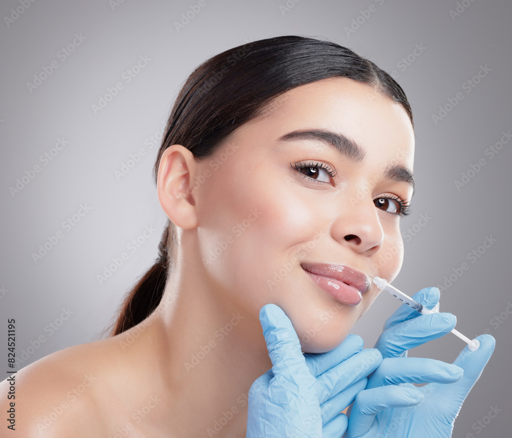 Hands, injection and woman with lip filler or plastic surgery for beauty on studio background. Botox, syringe and portrait of process to mouth in clinic with patient closeup or cosmetics treatment