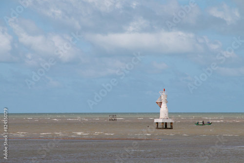 White light transmission tower in the sea photo