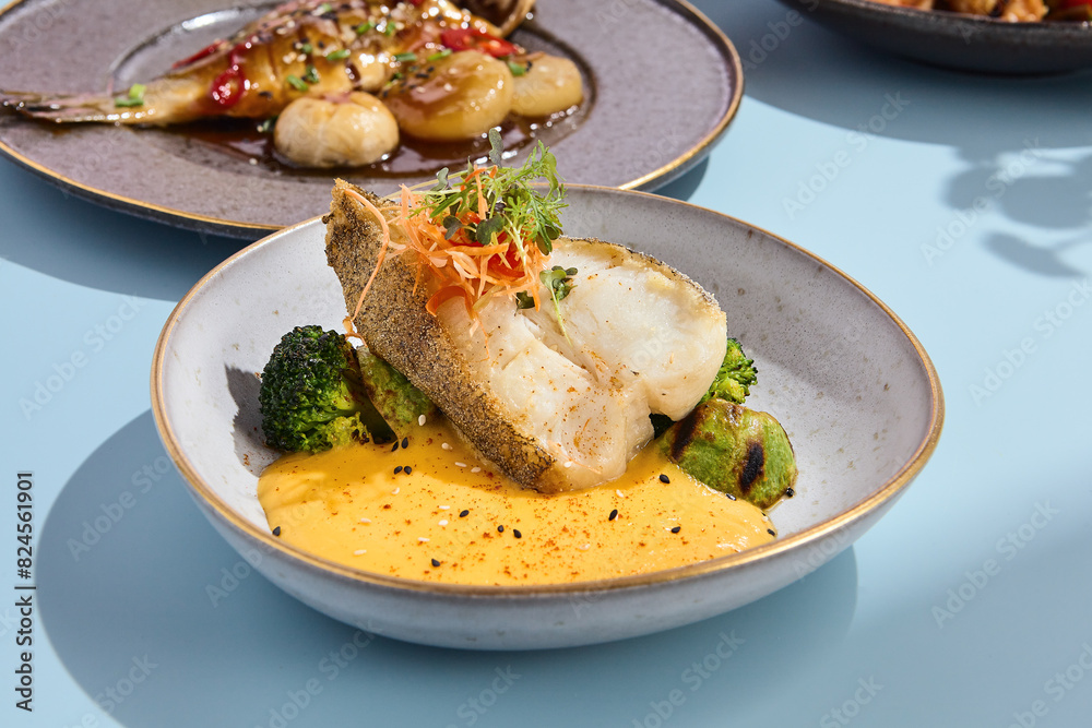 Halibut steak with pumpkin puree and broccoli, ideal for a vibrant summer menu in a high-end eatery Halibut steak with pumpkin puree and broccoli, ideal for a vibrant summer menu in a high-end eatery