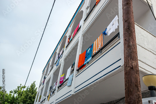 Drying beach towels, underwear and swimwear on a building in Greece.