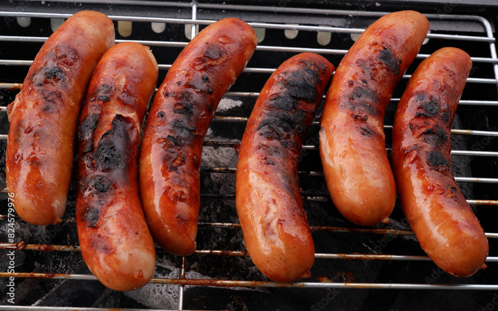 Top view of cooked sausages on bbq grill. Top view of cooked sausages on bbq grill.