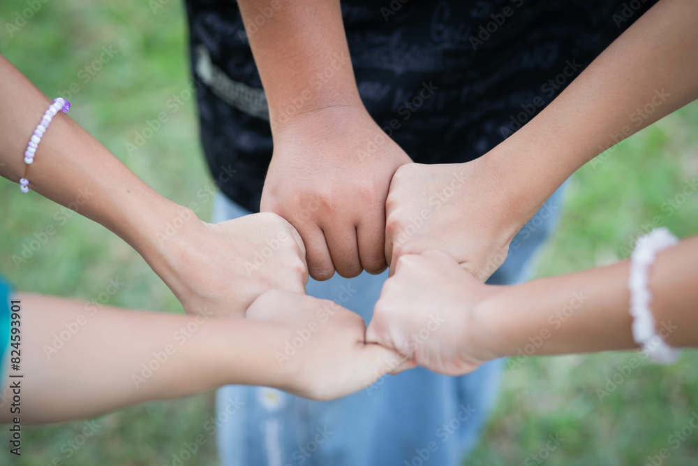 Closeup of diverse people holding hands Closeup of diverse people holding hands