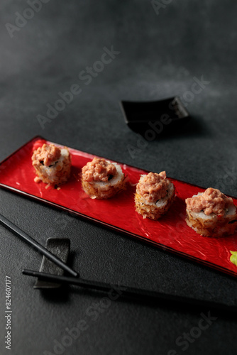 Japanese food: sushi, Shiitaki roll with tuna, avocado, Philadelphia, kimchi, tuna flakes Black background photo