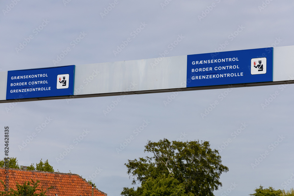 Sign in three languages Danish, English and German - Border control.
