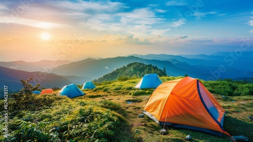 Tents pitched on a scenic mountain slope  ideal for travel or camping themes  vibrant outdoor setting with clear skies and lush greenery  isolated view