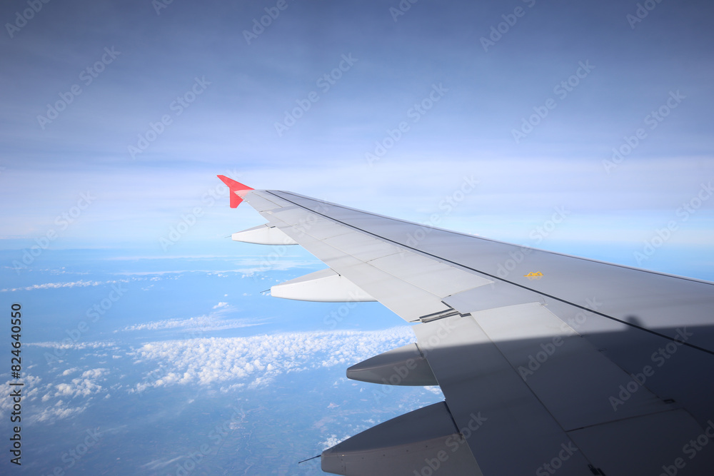 Amazing view from airplane window, Beautiful of Airplane wing with clouds and blue sky on sunset light background Amazing view from airplane window, Beautiful of Airplane wing with clouds and blue sky on sunset light background