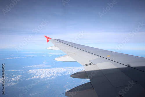 Amazing view from airplane window, Beautiful of Airplane wing with clouds and blue sky on sunset light background