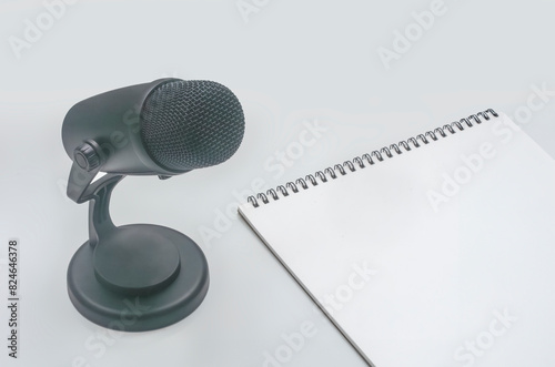 background with microphone and notepad on table photo