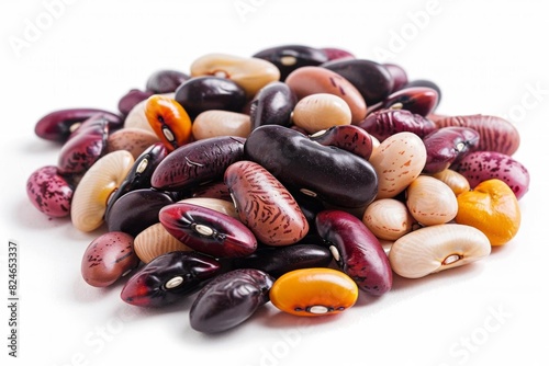 A colorful assortment of various dried beans on a white background, showcasing diversity in shape, size, and color.