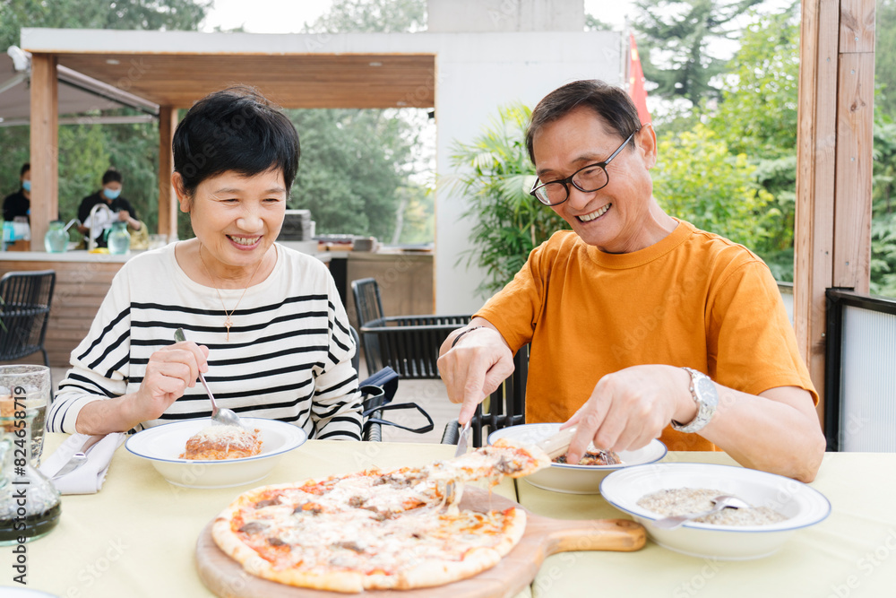 Happy Asian Senior mature married couple Enjoying Healthy Lunch Outdoors on a open air Sunny Terrace. on vacation in a sunny summer day Happy Asian Senior mature married couple Enjoying Healthy Lunch Outdoors on a open air Sunny Terrace. on vacation in a sunny summer day