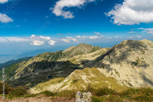 Retezat mountains with Papusa mountain peak from Peleaga mountain peak in Romania photo