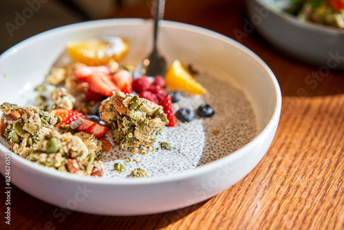 A mixture of strawberries, blueberries, and granola on a plate