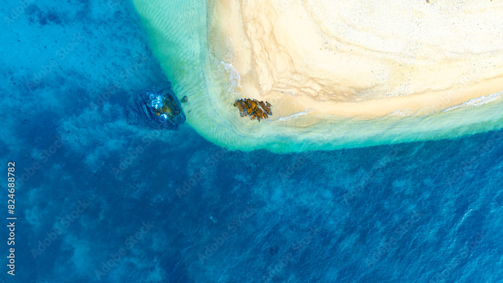 Fototapeta premium Top view nature of beach and sea Summer with sunshine, sandy beaches, clear blue waters sparkling against the blue sky. On an island with good ecology and environment Background for summer vacation