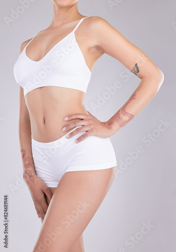 Body, tattoo and woman with underwear in studio for weight loss, transformation and progress. Female person, confident and relax on white background for health, tummy tuck and wellness results