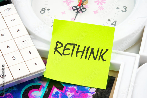 Rethink is shown using a text inscription on a yellow sticker on the background of the clock photo
