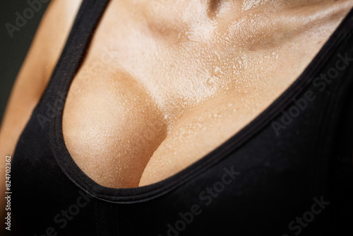 Closeup of sexy female boob in black bra. Sexy boob. Close up of breast of girl presenting her bra. Woman with big natural sexy boobs in lingerie. Plastic surgery.