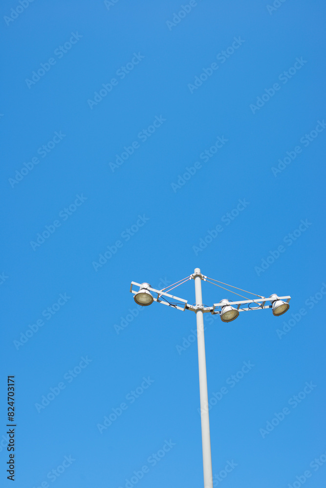 Close-up of a metal street lamp with clear blue sky Close-up of a metal street lamp with clear blue sky