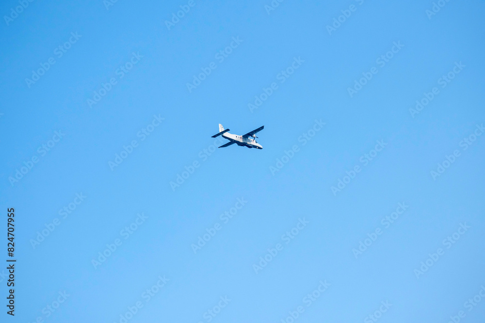 Propeller plane is flying on isolated blue sky Propeller plane is flying on isolated blue sky