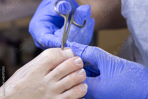 Young woman getting Pedicure with milling cutter in beauty salon  closeup