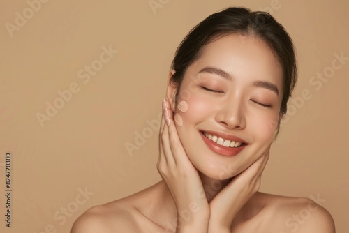 Young Asian woman touching her face with healthy skin.