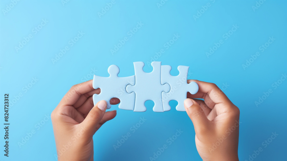 Hands holding a jigsaw puzzle on blue background, business concept Hands holding a jigsaw puzzle on blue background, business concept