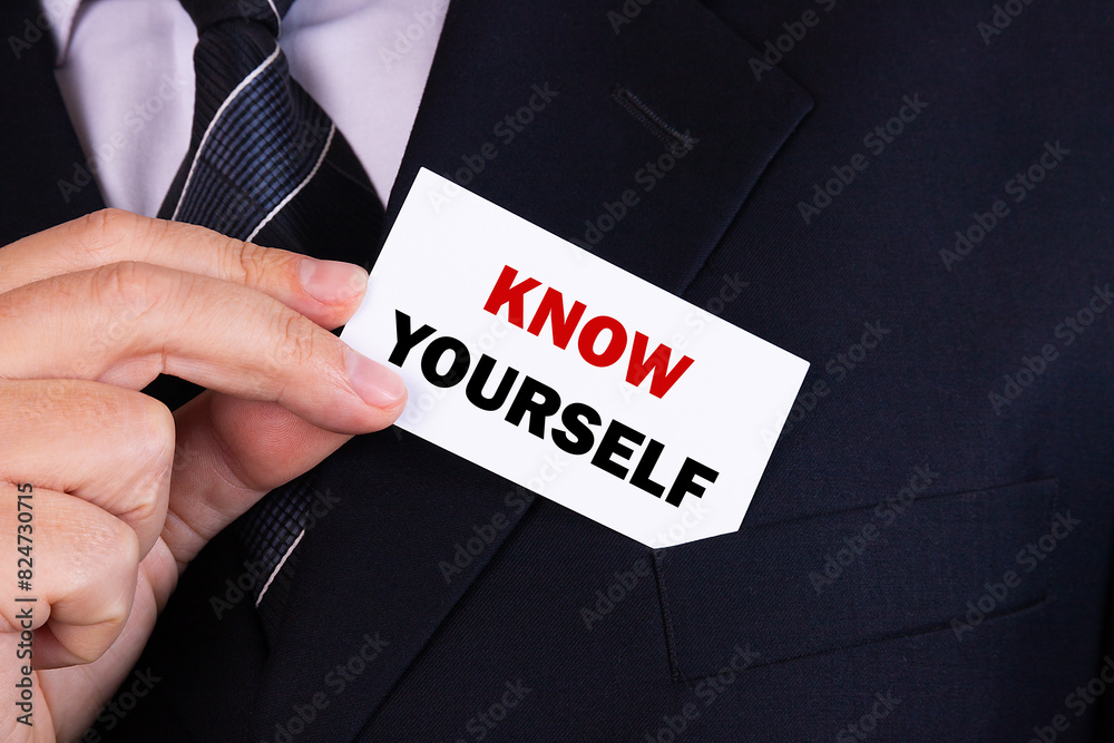 Obraz premium .Businessman putting a card with text know yourself in the pocket