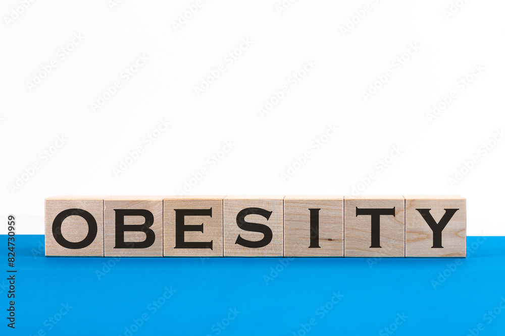 Word Obesity made with wood building blocks Word Obesity made with wood building blocks