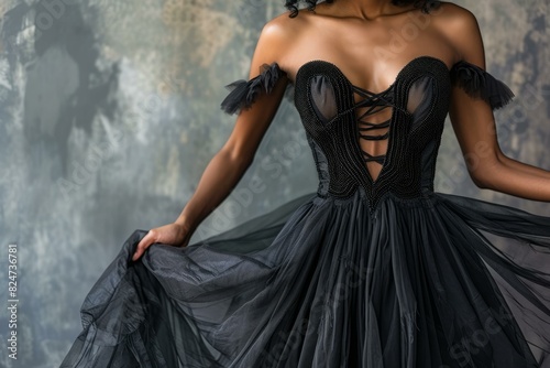 Cropped view of a woman adorned in a luxurious black dress with delicate lace detailing