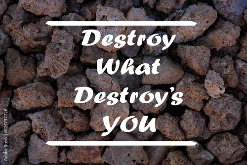 Valokuva Inspirational motivational quote - Destroy what destroys you written on a stone wall