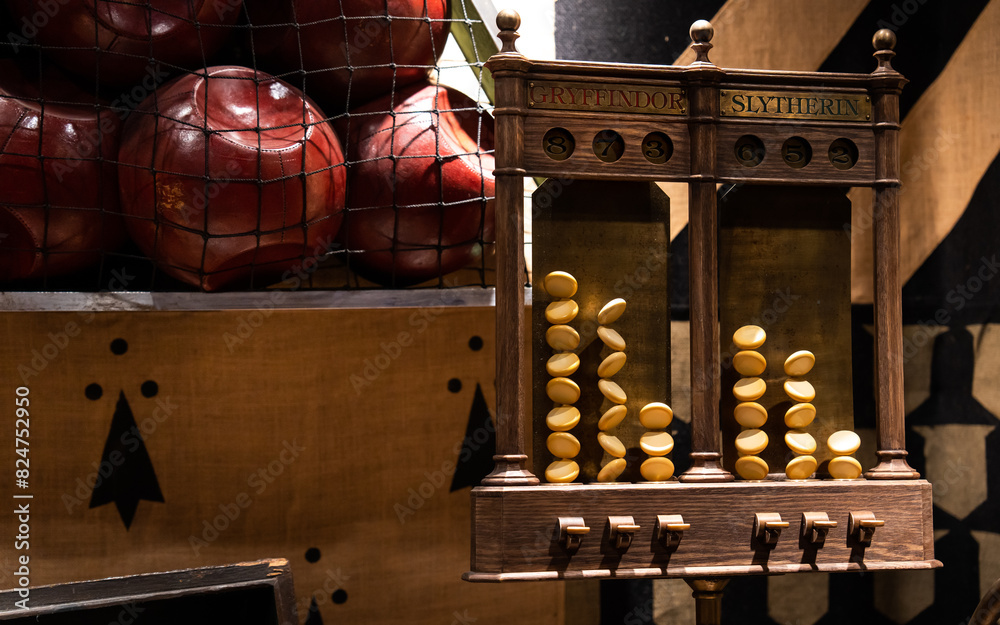 Obraz premium JAPAN - NOV 13, 2023: A wooden house point scoreboard for Gryffindor and Slytherin with tokens and red balls in a net at The Making of Harry Potter, Warner Bros Studio Tour Tokyo, Japan